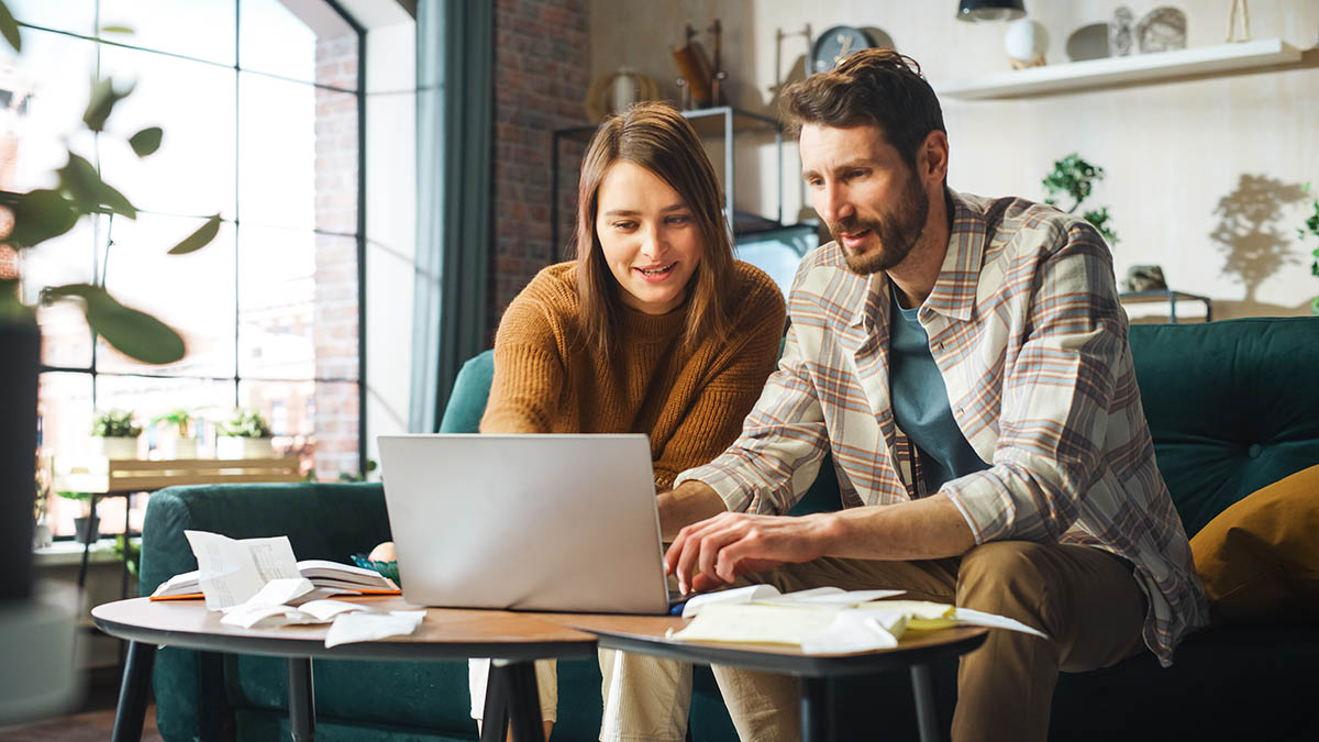 Ways to Save Big with HVAC Tax Credits 5 homeowners looking at a laptop